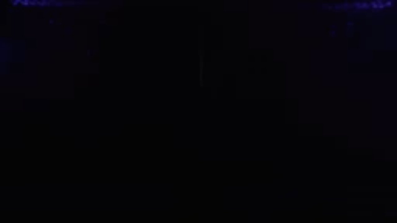 A dark stage, moments before the curtain opens on the MAD Entertainment showreel